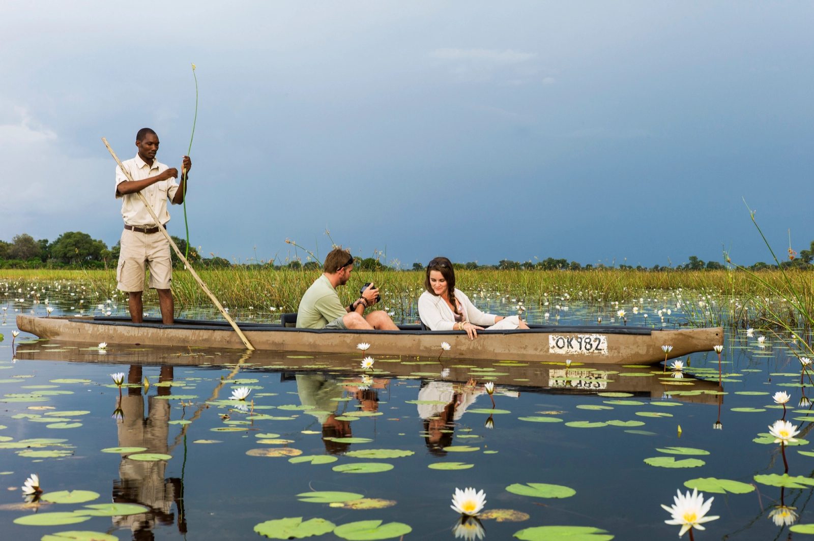 A mokoro gliding through the channels of the Okavango Delta