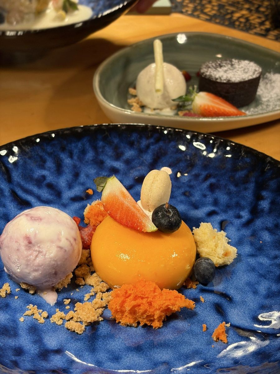 Plated passion fruit dessert with vanilla ice cream, fresh strawberries and crumble at the Japanese restaurant, St Regis Mauritius Le Morne