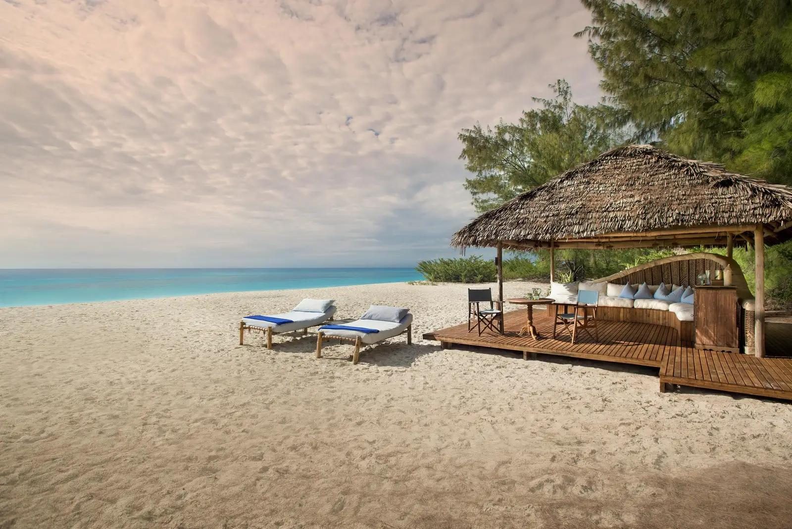 A thatched beach banda on the white sand of Mnemba Island
