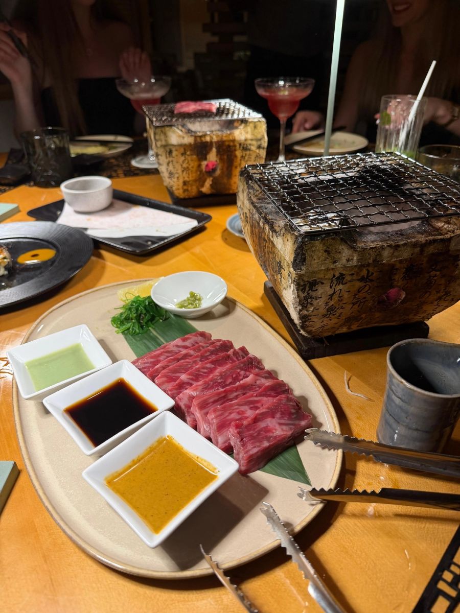 Sliced raw wagyu on a green leaf with three dipping sauces and two tabletop binchotan grills at the St Regis Japanese restaurant, Le Morne, Mauritius