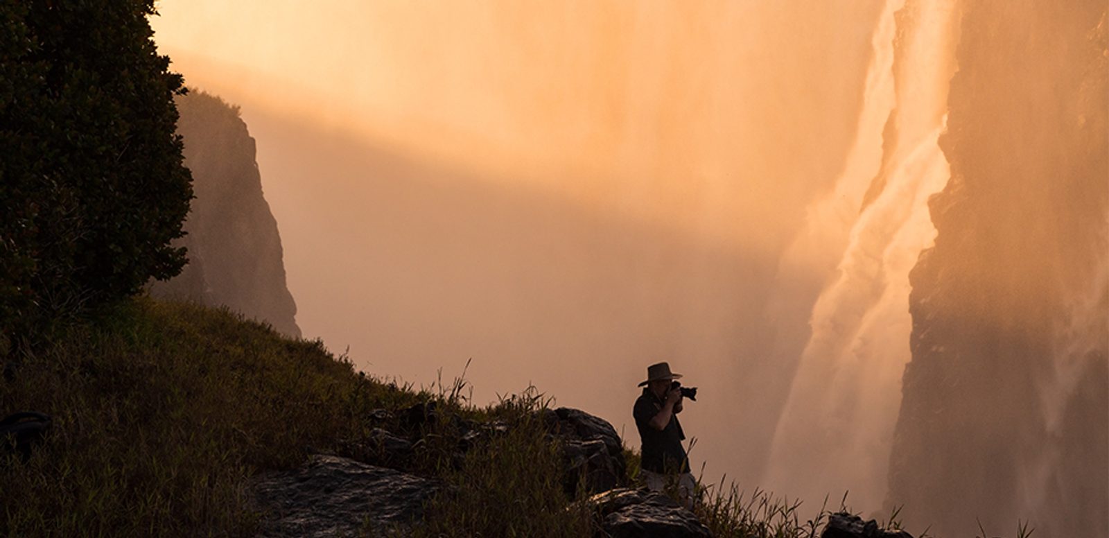 Photographer taking a spectacular photo on Zambia's border side of the mighty Vic Falls.