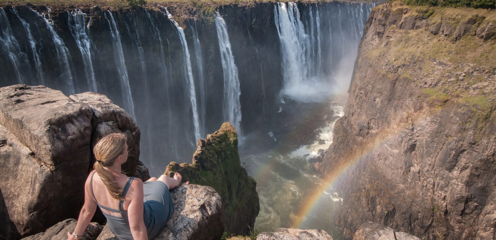 Victoria falls offer some travelers this lucky, spectacular view of rainbow and silk water found at Rainbow Falls, Zimbabwe.